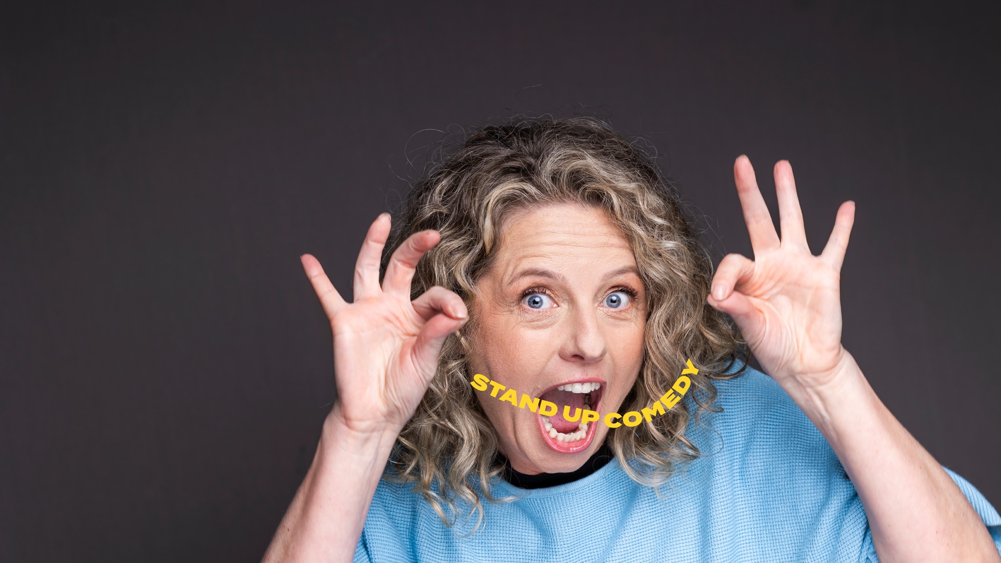 Headshot of Heidi Lynne Weeks holding up an invisible string with Stand Up written on it.